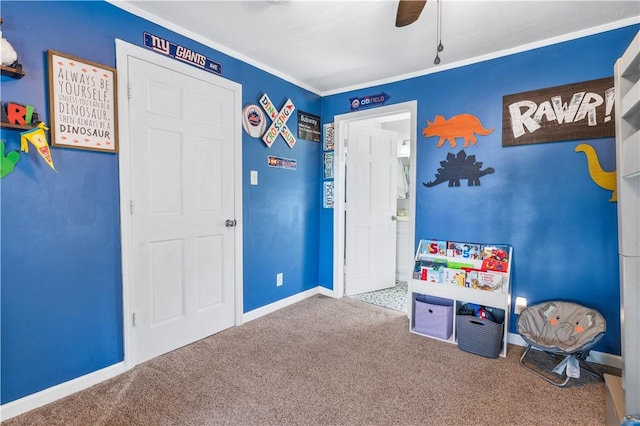 game room with ceiling fan, carpet floors, and ornamental molding