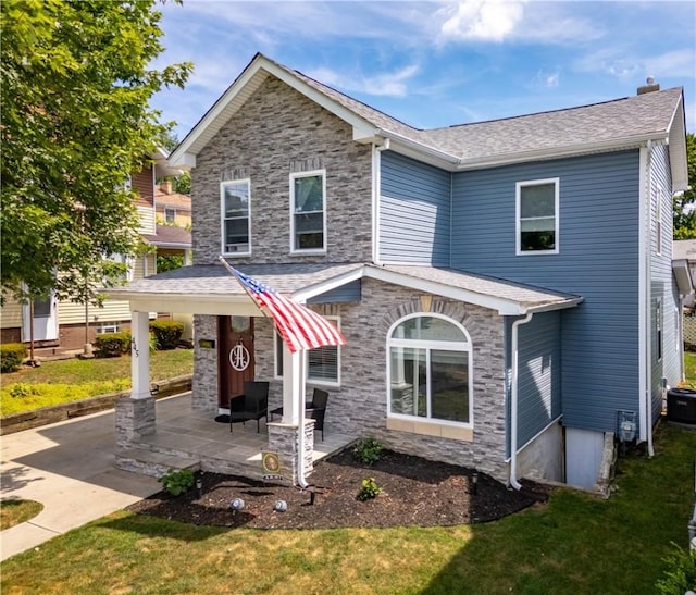 view of front of house with a patio area and a front yard