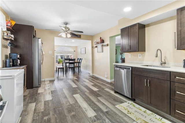 kitchen featuring sink, ceiling fan, dark brown cabinets, light hardwood / wood-style floors, and stainless steel appliances