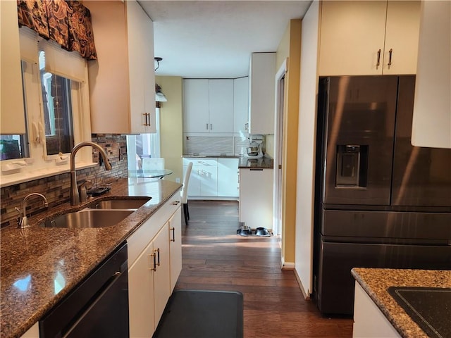 kitchen featuring white cabinetry, dark stone countertops, sink, and black appliances