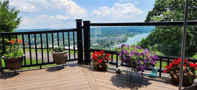 wooden terrace featuring a water view