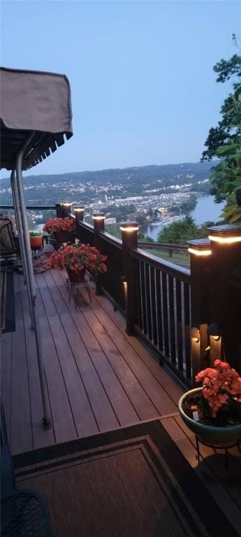 wooden terrace featuring a water view