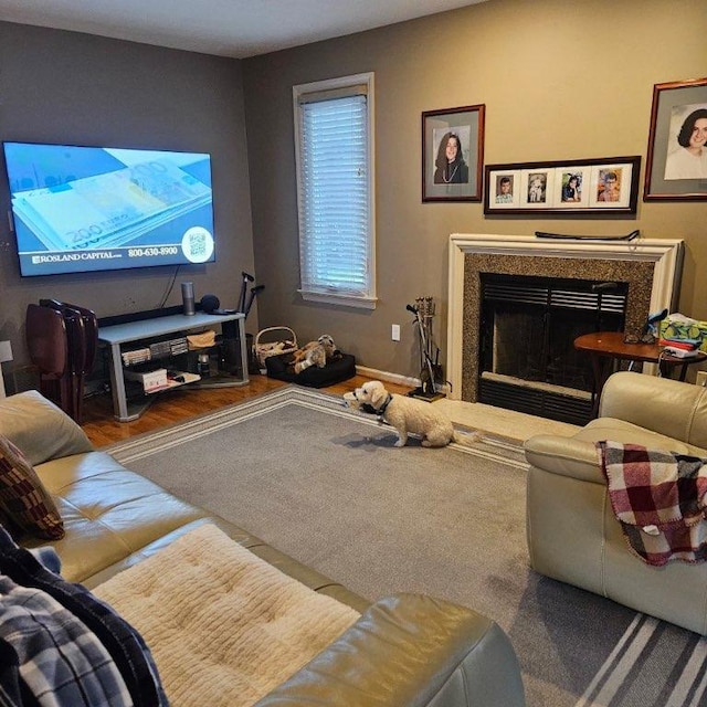 living room featuring hardwood / wood-style floors and a high end fireplace