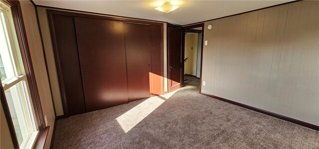 unfurnished bedroom with carpet floors and a closet