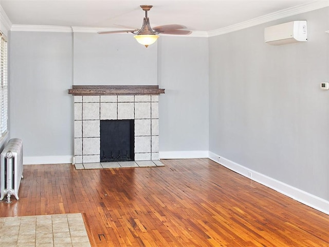 unfurnished living room with wood-type flooring, radiator heating unit, crown molding, and a wall mounted AC