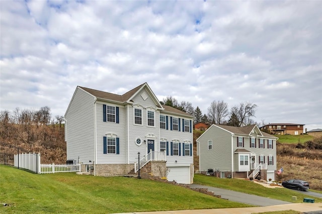 view of front of home with a front yard and a garage