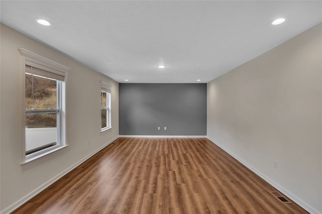 unfurnished room with wood-type flooring