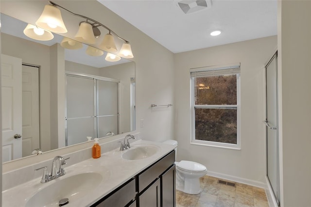 bathroom featuring vanity, an enclosed shower, and toilet