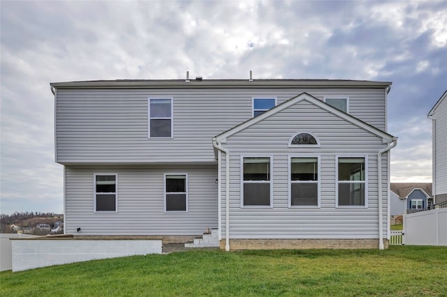 back of house with a lawn