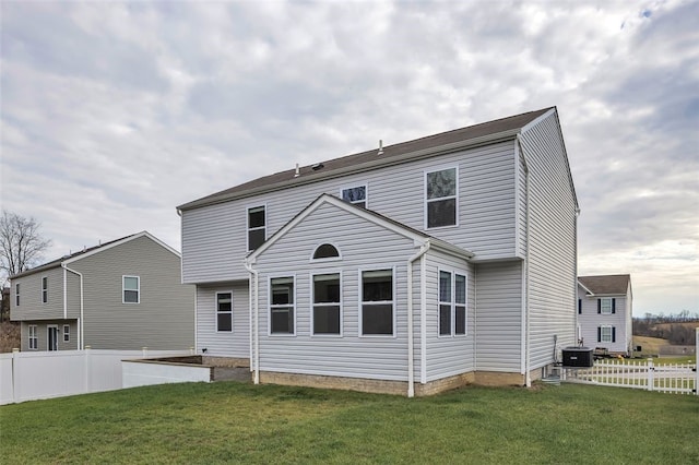 back of property featuring a yard and central AC unit