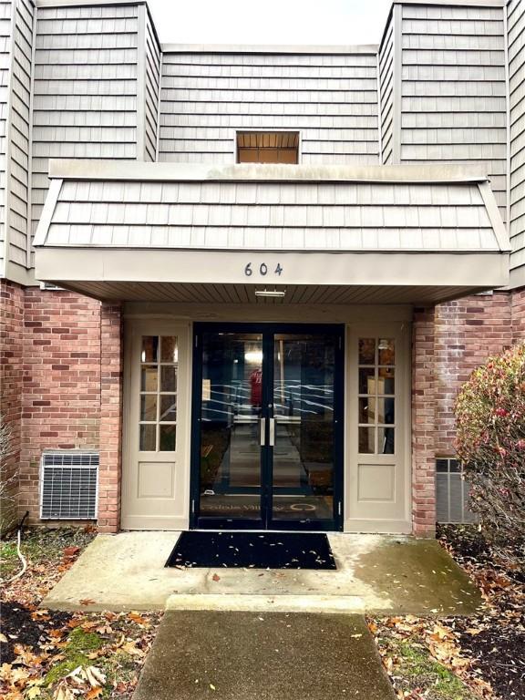 entrance to property featuring a balcony and french doors