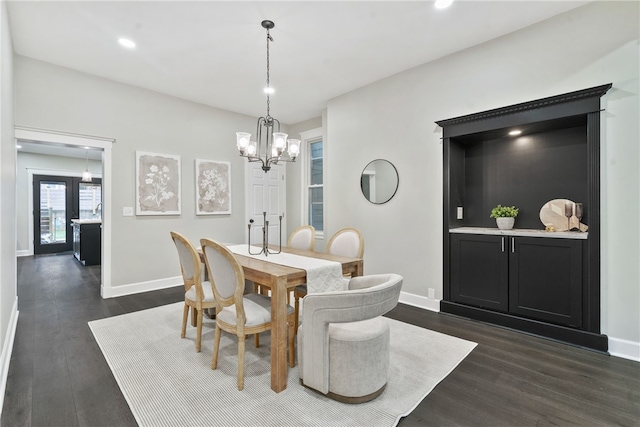 dining area featuring french doors, dark hardwood / wood-style floors, and an inviting chandelier