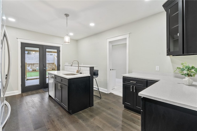 kitchen featuring dark hardwood / wood-style flooring, sink, decorative light fixtures, dishwasher, and fridge