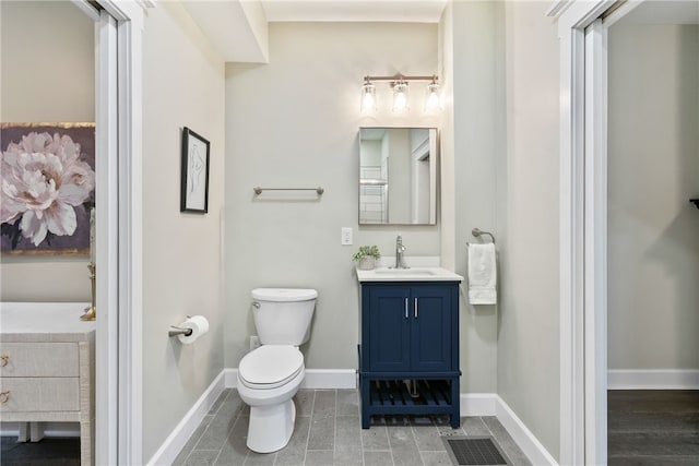 bathroom with vanity, wood-type flooring, and toilet