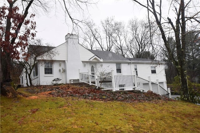 back of property featuring a yard and a garage