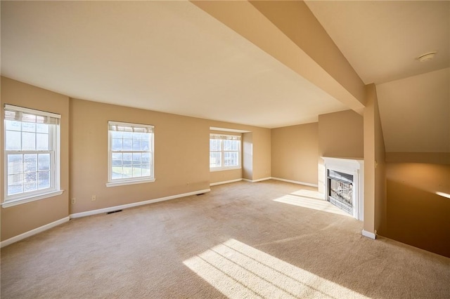 unfurnished living room featuring light carpet