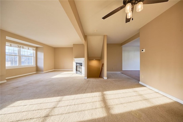 unfurnished living room with light carpet and ceiling fan