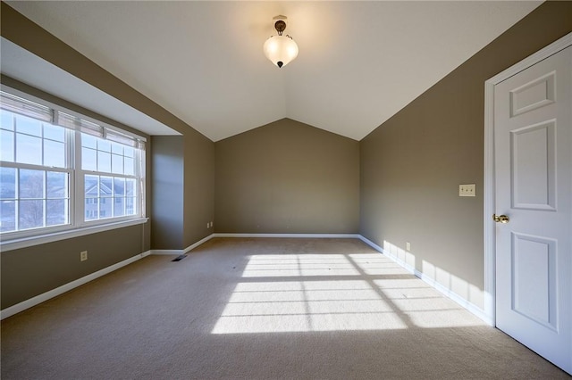 bonus room featuring light colored carpet and lofted ceiling