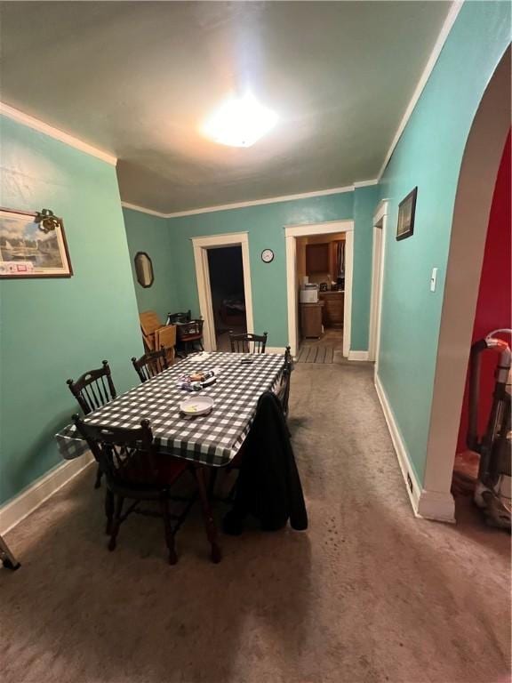 dining area with carpet flooring and ornamental molding