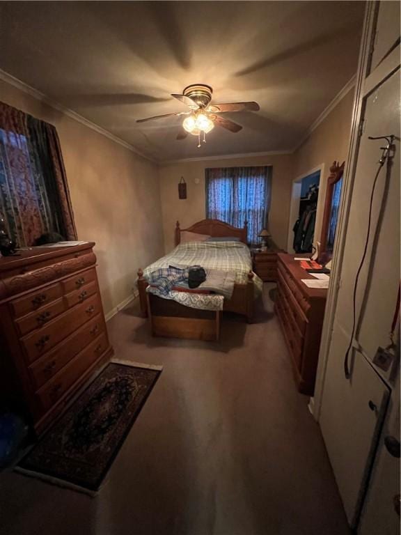 carpeted bedroom featuring ceiling fan and ornamental molding