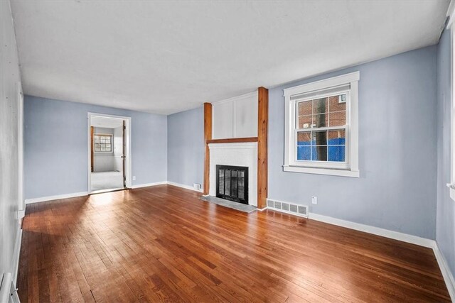 unfurnished living room featuring hardwood / wood-style flooring