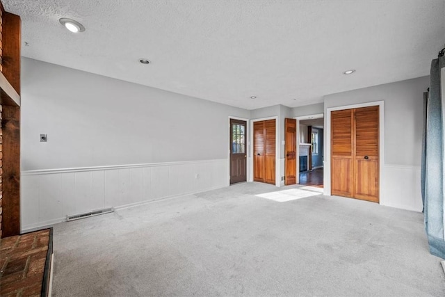 unfurnished bedroom with carpet and a textured ceiling