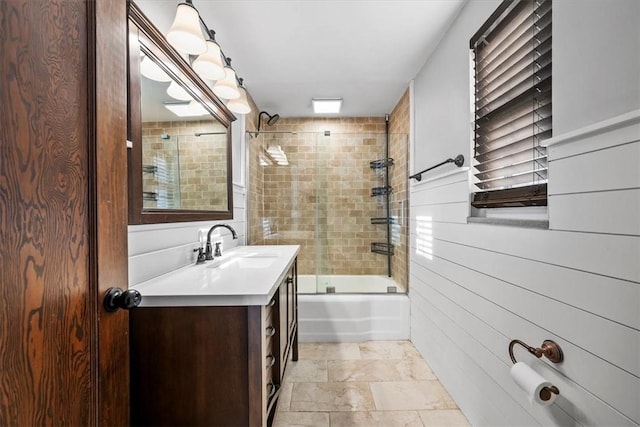 bathroom featuring vanity and bath / shower combo with glass door