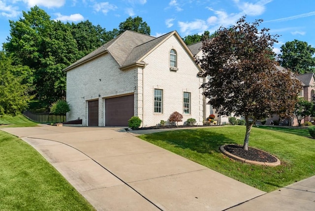 view of front facade featuring a front lawn and a garage