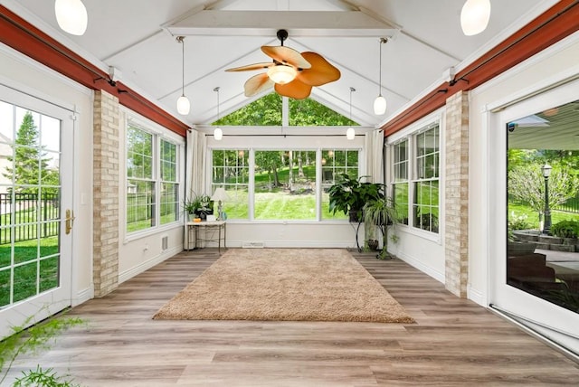 unfurnished sunroom featuring ceiling fan and lofted ceiling with beams