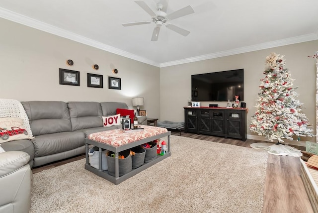 living room featuring hardwood / wood-style floors, ceiling fan, and crown molding