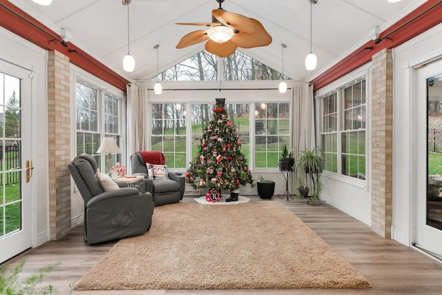 sunroom featuring ceiling fan and lofted ceiling