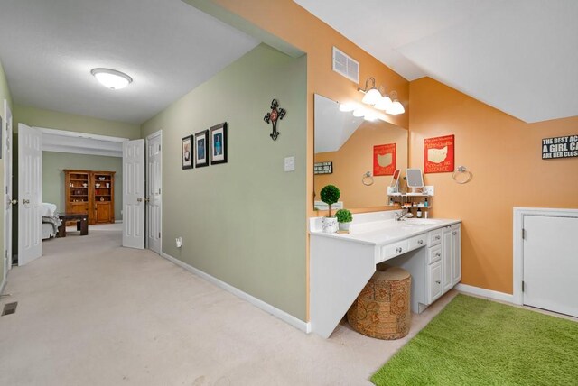 bathroom featuring vanity and vaulted ceiling