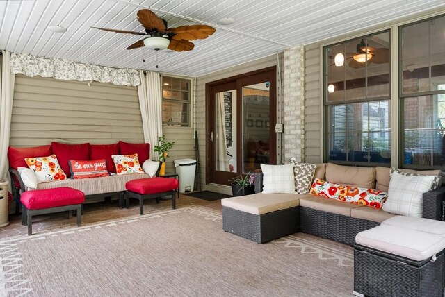 sunroom featuring ceiling fan and wooden ceiling