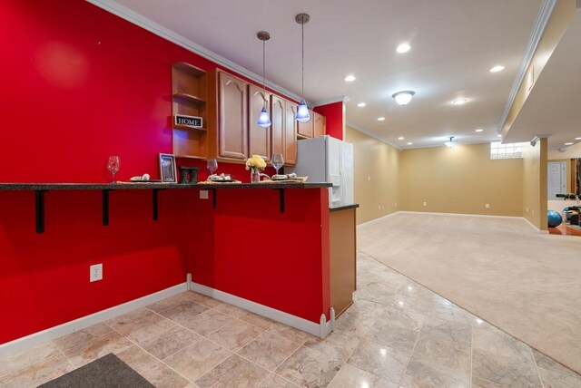 kitchen featuring a breakfast bar, white refrigerator with ice dispenser, crown molding, decorative light fixtures, and light colored carpet