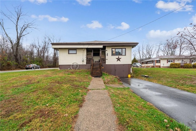 bungalow-style house with a front yard