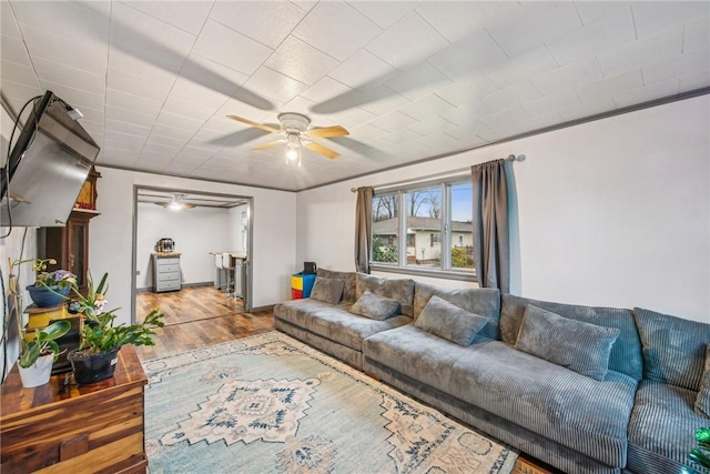 living room featuring ceiling fan and hardwood / wood-style floors