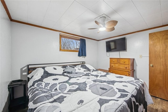 bedroom featuring ceiling fan, crown molding, and hardwood / wood-style flooring