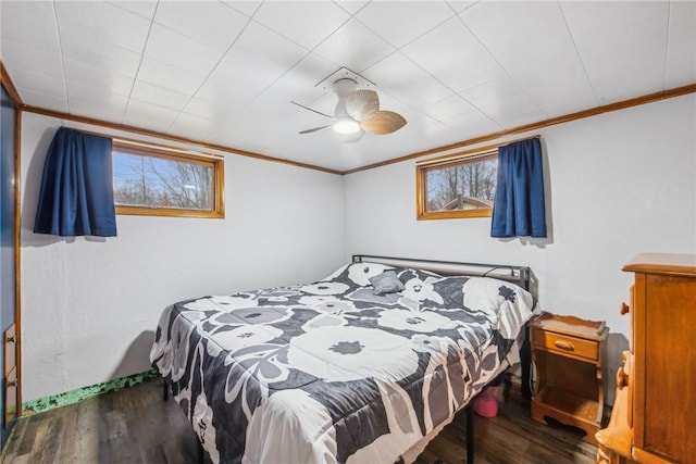 bedroom with ceiling fan, wood-type flooring, and ornamental molding