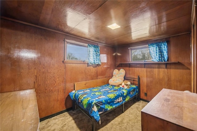 carpeted bedroom with wood ceiling and wood walls