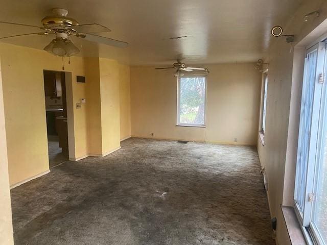 spare room featuring dark colored carpet