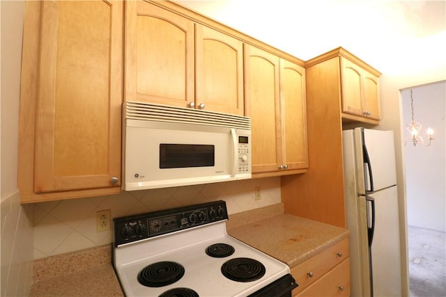 kitchen featuring decorative backsplash, light brown cabinetry, and white appliances