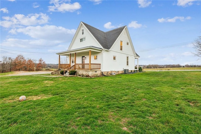 view of front of home with central AC, covered porch, and a front lawn