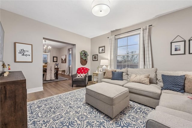 living room with hardwood / wood-style flooring and an inviting chandelier