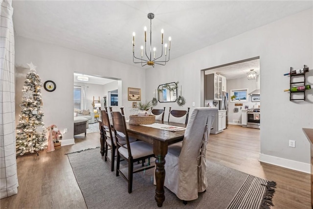 dining space with hardwood / wood-style floors and a chandelier