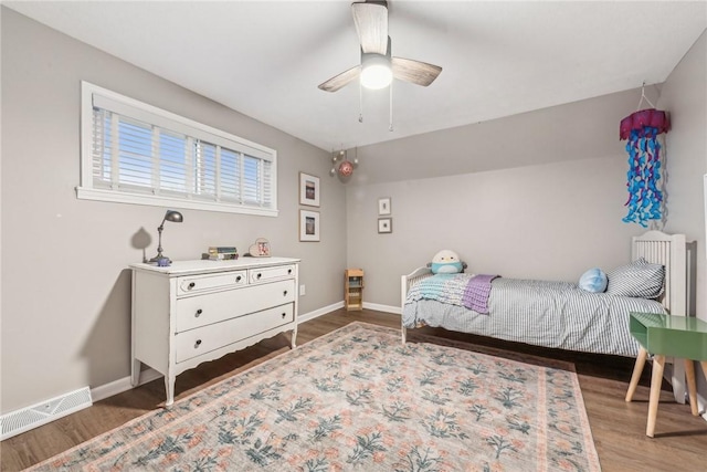 bedroom with ceiling fan and dark hardwood / wood-style flooring