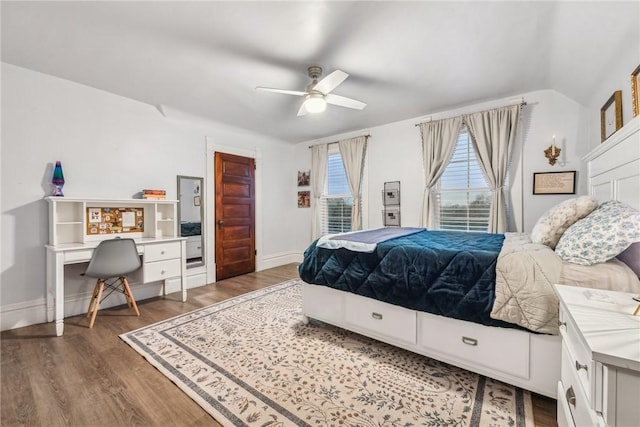 bedroom featuring dark hardwood / wood-style flooring, ceiling fan, and lofted ceiling