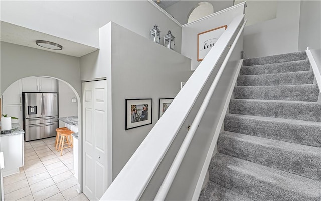 stairway with tile patterned flooring