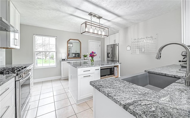 kitchen with a center island, sink, white cabinetry, and stainless steel appliances