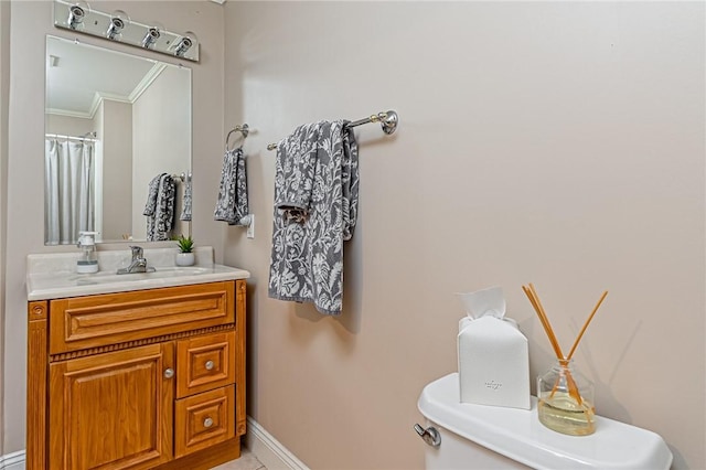 bathroom featuring vanity, toilet, and ornamental molding