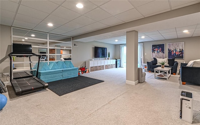 interior space with a drop ceiling and carpet floors